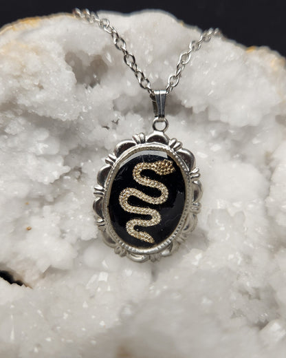 Collier serpent doré – médaillon noir résine sur chaîne acier